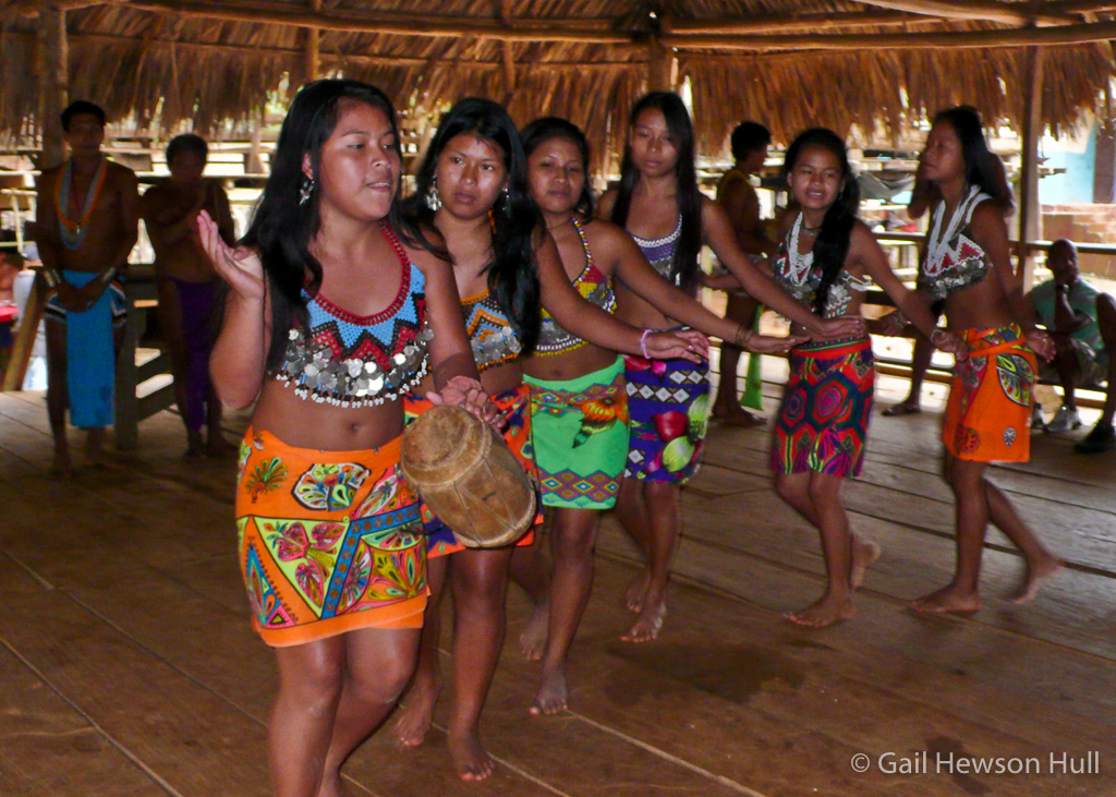 Adolescent girls dance demurely for paying guests.